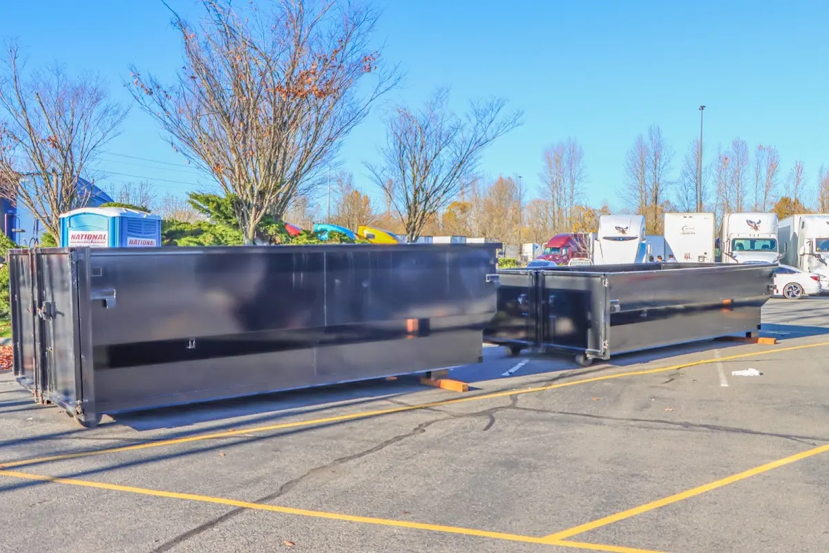 Professional dumpster rental service with roll-off container on residential driveway in Zion